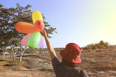 Woman holding a balloon on a big cliff, pha taem ubonratchathani thailand.