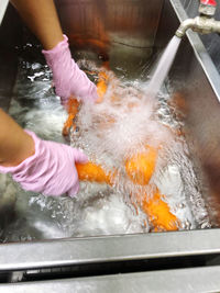 Midsection of person preparing food in water