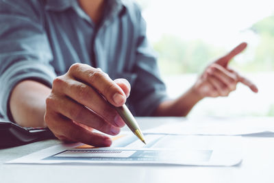 Cropped image of man making face on table