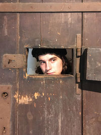 Portrait of boy peeking through door