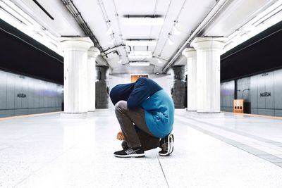 Rear view of man sitting on seat in bus