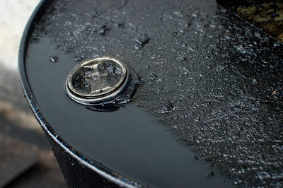 High angle view of raindrops on wet metal