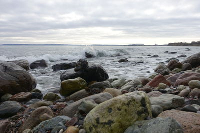 Rocks in sea against sky