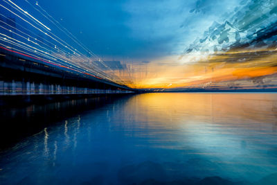 Scenic view of illuminated bridge against sky during sunset