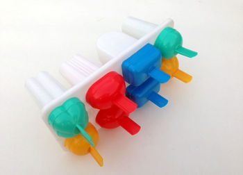 High angle view of colored pencils on white background