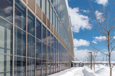 Low angle view of glass building against sky