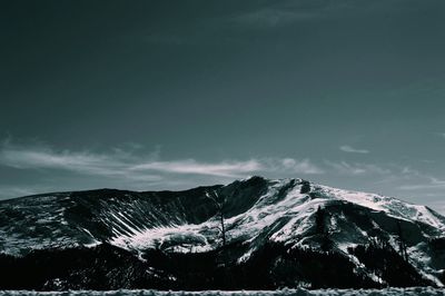 Scenic view of snow covered mountains against sky