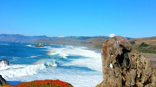 Panoramic view of sea against clear blue sky