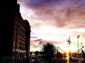 Low angle view of silhouette buildings against sky during sunset