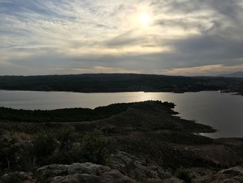 Scenic view of lake against sky during sunset