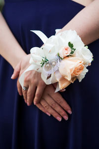 Midsection of bride with roses