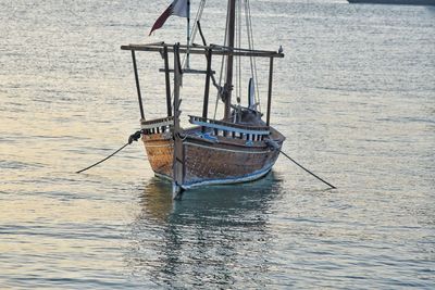 Fishing boat sailing in sea against sky