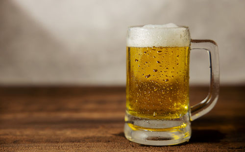 Close-up of beer glass on table