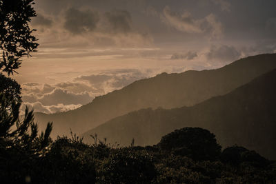 Scenic view of silhouette mountains against sky at sunset