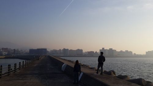 Bridge over river at sunset