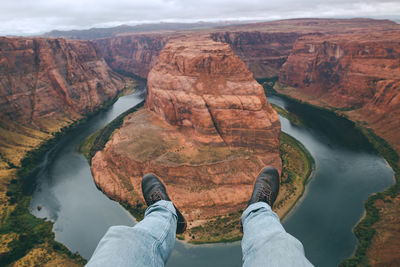 Low section of man standing on rock formation