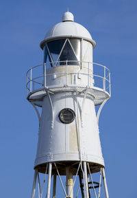 Low angle view of lighthouse against clear blue sky