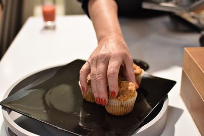 Close-up of person preparing food in plate