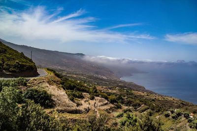 Scenic view of sea and mountains against sky