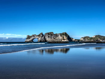 Scenic view of sea against clear blue sky