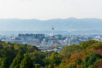 Scenic view of cityscape by sea against sky