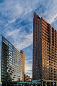 Low angle view of modern buildings against sky in city