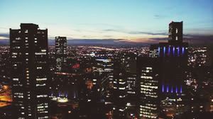 VIEW OF CITY LIT UP AT NIGHT