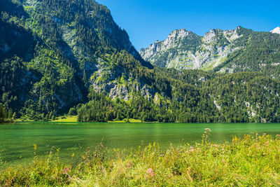 Scenic view of lake and mountains against sky