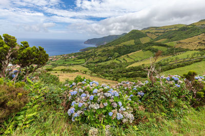 Scenic view of sea and mountains against sky