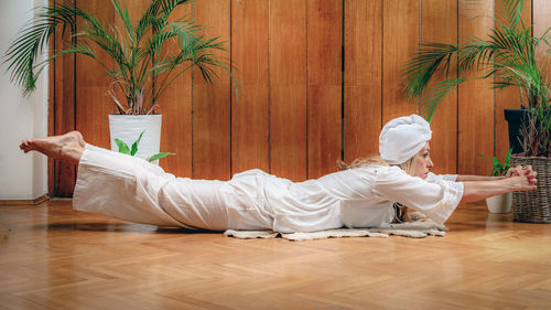 Woman practicing kundalini yoga, kriya exercises for the navel center and bowel waste elimination