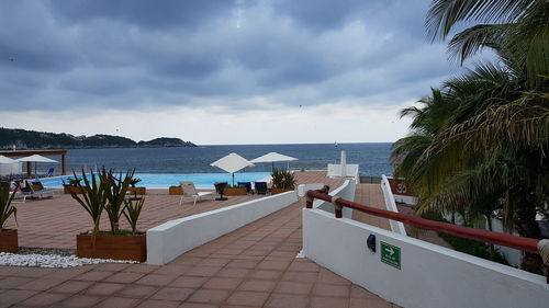 View of swimming pool at beach against sky