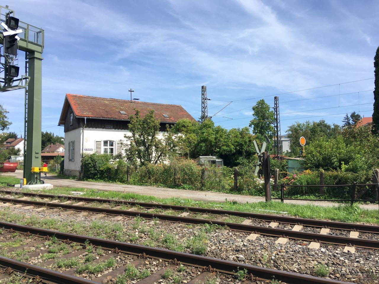 RAILROAD TRACKS AMIDST BUILDINGS AGAINST SKY