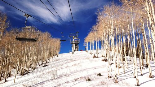 Ski lift against sky during winter