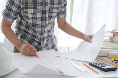 Low angle view of man working on table