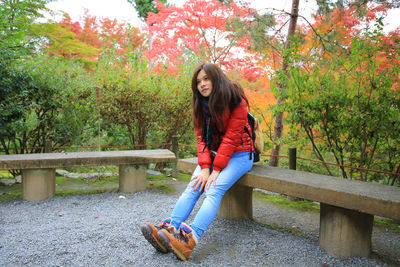 Full length of woman sitting at park