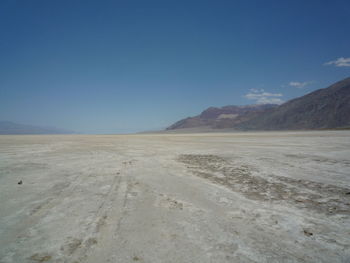 Scenic view of desert against clear blue sky