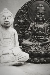 Close-up of buddha statue against building