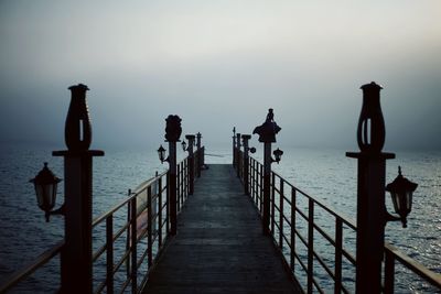 Pier over sea against sky