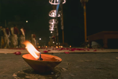 Lit tea light candles in temple at night