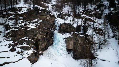 Snow covered rock on landscape during winter