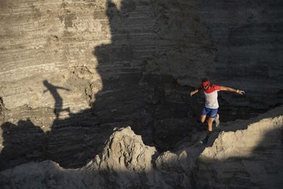 One man trail running down through a ridge on a sandy terrain