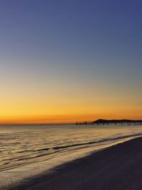 Scenic view of sea against clear sky during sunset