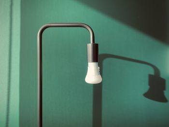 Close-up of electric lamp against wall