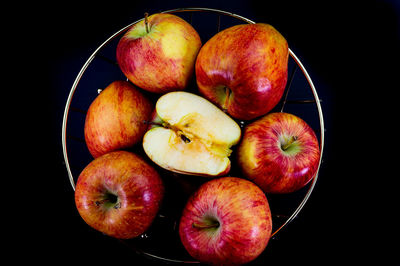 High angle view of apples in bowl against black background