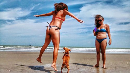 Full length of woman on beach against sky