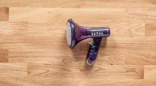 High angle view of umbrella on wooden floor