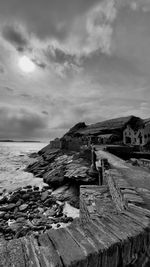 View of beach against cloudy sky