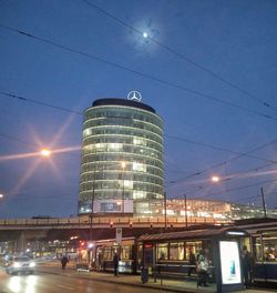 Low angle view of illuminated city against sky at night