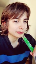 Close-up of woman eating food at home