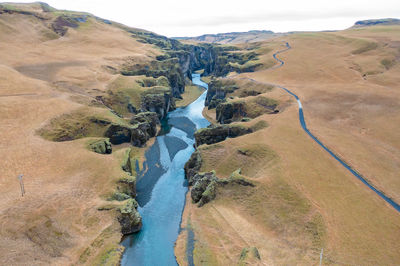 Wide estuary between hills in iceland, winding blue river, stream. tourist picturesque landscape.